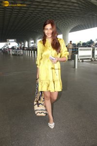 actress Surbhi Chandna beautiful in a yellow dress at mumbai airport