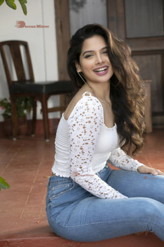 Model and Telugu Actress Tanya Hope in a white top and blue jeans