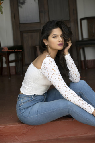 Model and Telugu Actress Tanya Hope in a white top and blue jeans