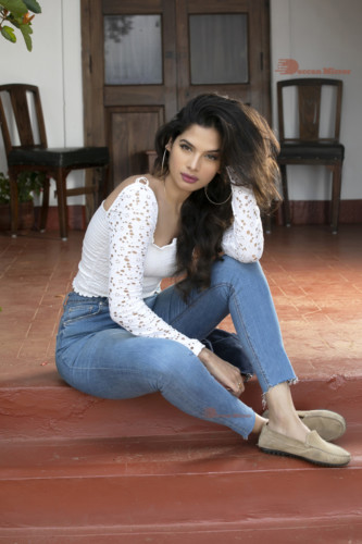Model and Telugu Actress Tanya Hope in a white top and blue jeans
