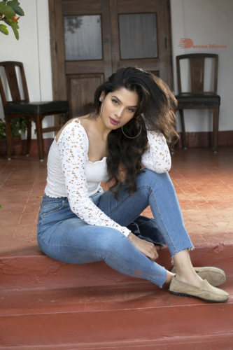 Model and Telugu Actress Tanya Hope in a white top and blue jeans