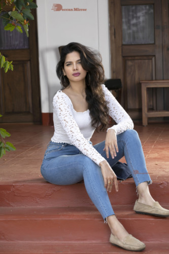 Model and Telugu Actress Tanya Hope in a white top and blue jeans