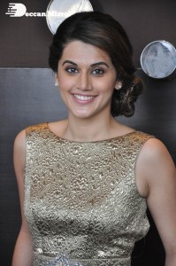 Tapsee Pannu in a dark gold colored dress