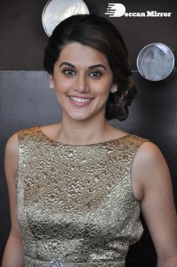 Tapsee Pannu in a dark gold colored dress