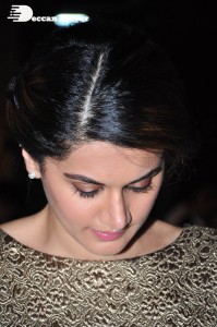 Tapsee Pannu in a dark gold colored dress