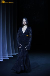 Bollywood actress Tara Sutaria in a black dress doing a ramp walk