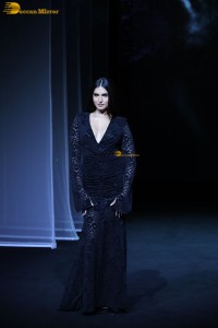 Bollywood actress Tara Sutaria in a black dress doing a ramp walk