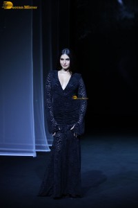 Bollywood actress Tara Sutaria in a black dress doing a ramp walk