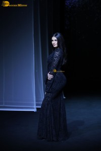 Bollywood actress Tara Sutaria in a black dress doing a ramp walk