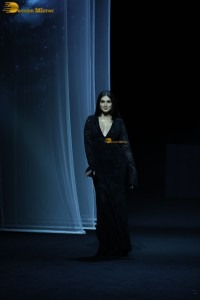 Bollywood actress Tara Sutaria in a black dress doing a ramp walk