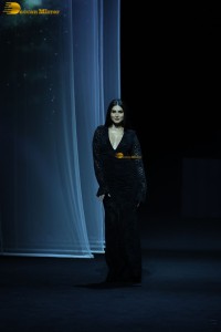 Bollywood actress Tara Sutaria in a black dress doing a ramp walk