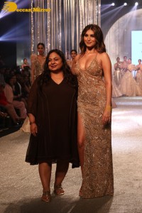 Tara Sutaria wearing a gold color dress for her ramp walk at Bombay Times Fashion Week