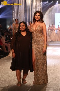 Tara Sutaria wearing a gold color dress for her ramp walk at Bombay Times Fashion Week