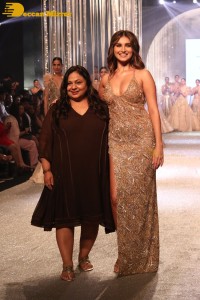 Tara Sutaria wearing a gold color dress for her ramp walk at Bombay Times Fashion Week