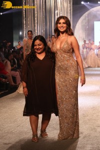 Tara Sutaria wearing a gold color dress for her ramp walk at Bombay Times Fashion Week