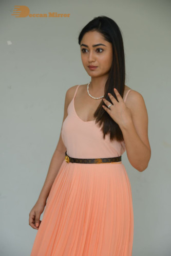 Telugu Actress Tridha Choudhury photoshoot in a orange top and skirt