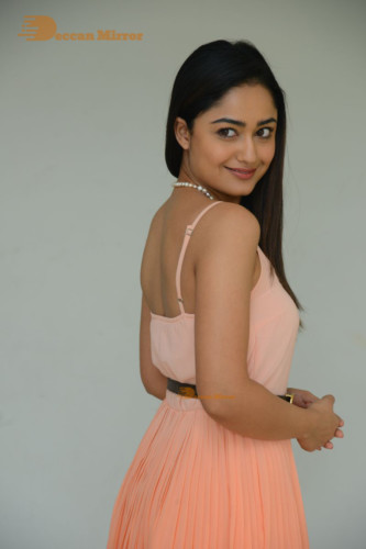 Telugu Actress Tridha Choudhury photoshoot in a orange top and skirt