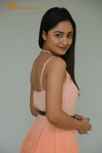 Telugu Actress Tridha Choudhury photoshoot in a orange top and skirt