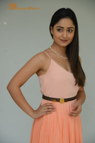 Telugu Actress Tridha Choudhury photoshoot in a orange top and skirt