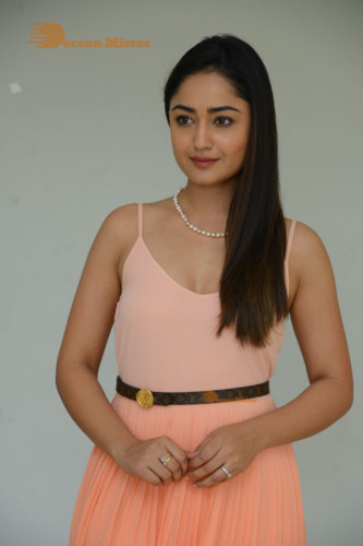 Telugu Actress Tridha Choudhury photoshoot in a orange top and skirt
