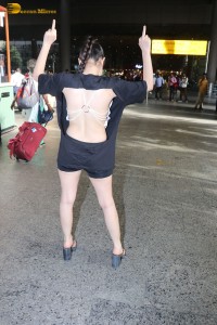 actress urfi javed in a open back black dress at airport