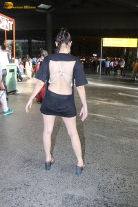 actress urfi javed in a open back black dress at airport
