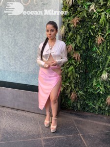 Urfi Javed in a pink shirt and a slit pink skirt