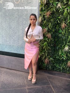 Urfi Javed in a pink shirt and a slit pink skirt
