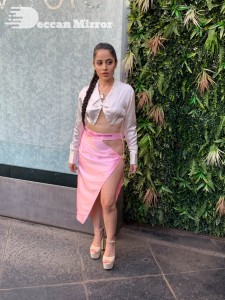 Urfi Javed in a pink shirt and a slit pink skirt