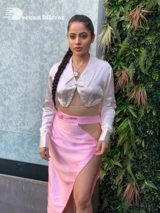 Urfi Javed in a pink shirt and a slit pink skirt