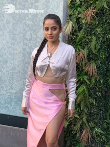 Urfi Javed in a pink shirt and a slit pink skirt