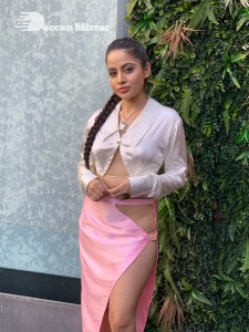 Urfi Javed in a pink shirt and a slit pink skirt