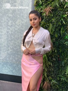 Urfi Javed in a pink shirt and a slit pink skirt