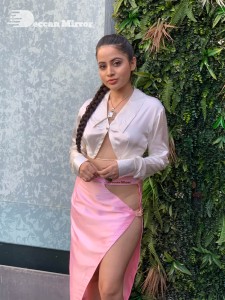 Urfi Javed in a pink shirt and a slit pink skirt