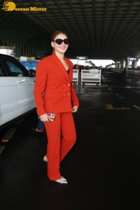 Urvashi Rautela in a red pant suit at the Mumbai Airport