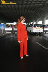 Urvashi Rautela in a red pant suit at the Mumbai Airport