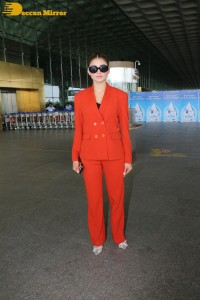 Urvashi Rautela in a red pant suit at the Mumbai Airport
