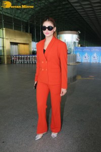 Urvashi Rautela in a red pant suit at the Mumbai Airport