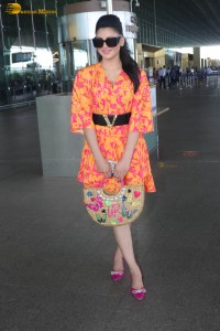 indian actress urvashi rautela in a orange dress at the airport
