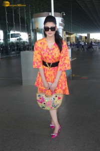 indian actress urvashi rautela in a orange dress at the airport