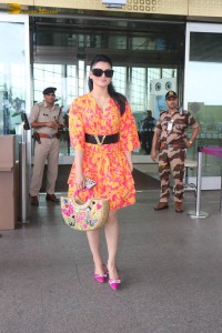 indian actress urvashi rautela in a orange dress at the airport