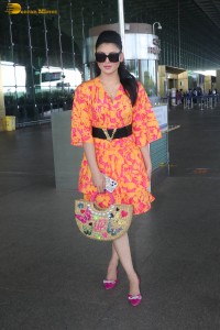 indian actress urvashi rautela in a orange dress at the airport