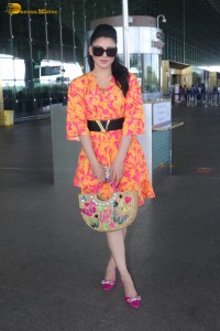 indian actress urvashi rautela in a orange dress at the airport