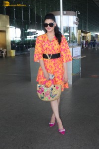 indian actress urvashi rautela in a orange dress at the airport