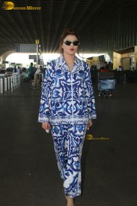 Bollywood actress Urvashi Rautela dressed in blue and white