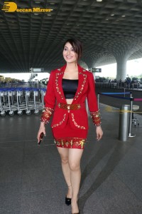 Actress Urvashi Rautela is seen at Mumbai Airport dressed in a red coat and skirt