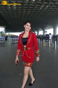 Actress Urvashi Rautela is seen at Mumbai Airport dressed in a red coat and skirt