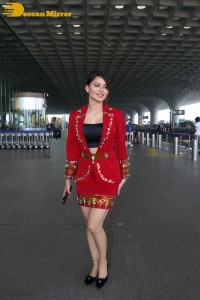 Actress Urvashi Rautela is seen at Mumbai Airport dressed in a red coat and skirt