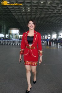 Actress Urvashi Rautela is seen at Mumbai Airport dressed in a red coat and skirt