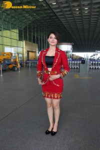 Actress Urvashi Rautela is seen at Mumbai Airport dressed in a red coat and skirt